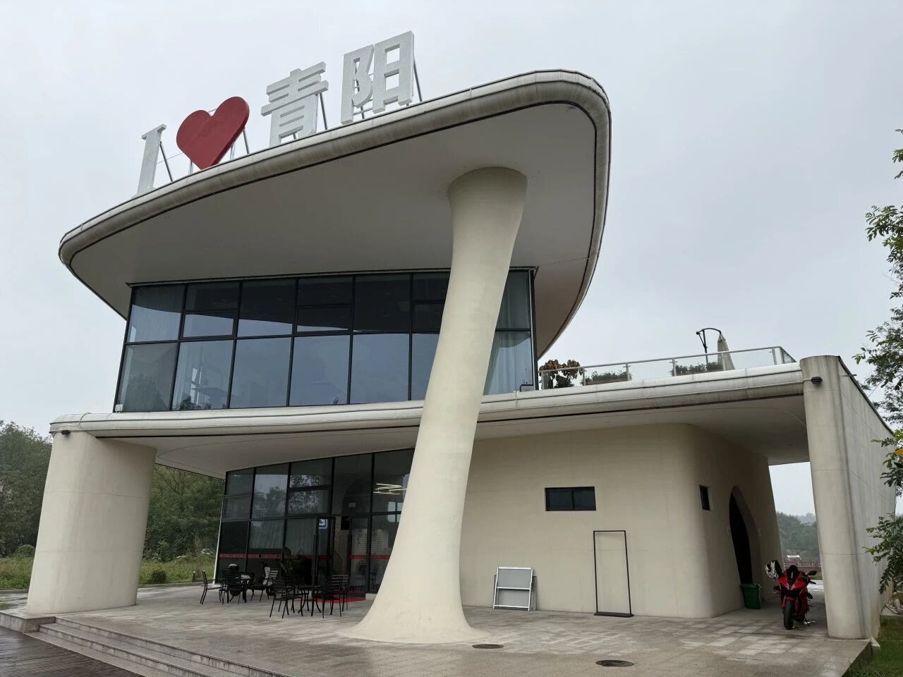 The completed building's front facade with its flowing curved lines.