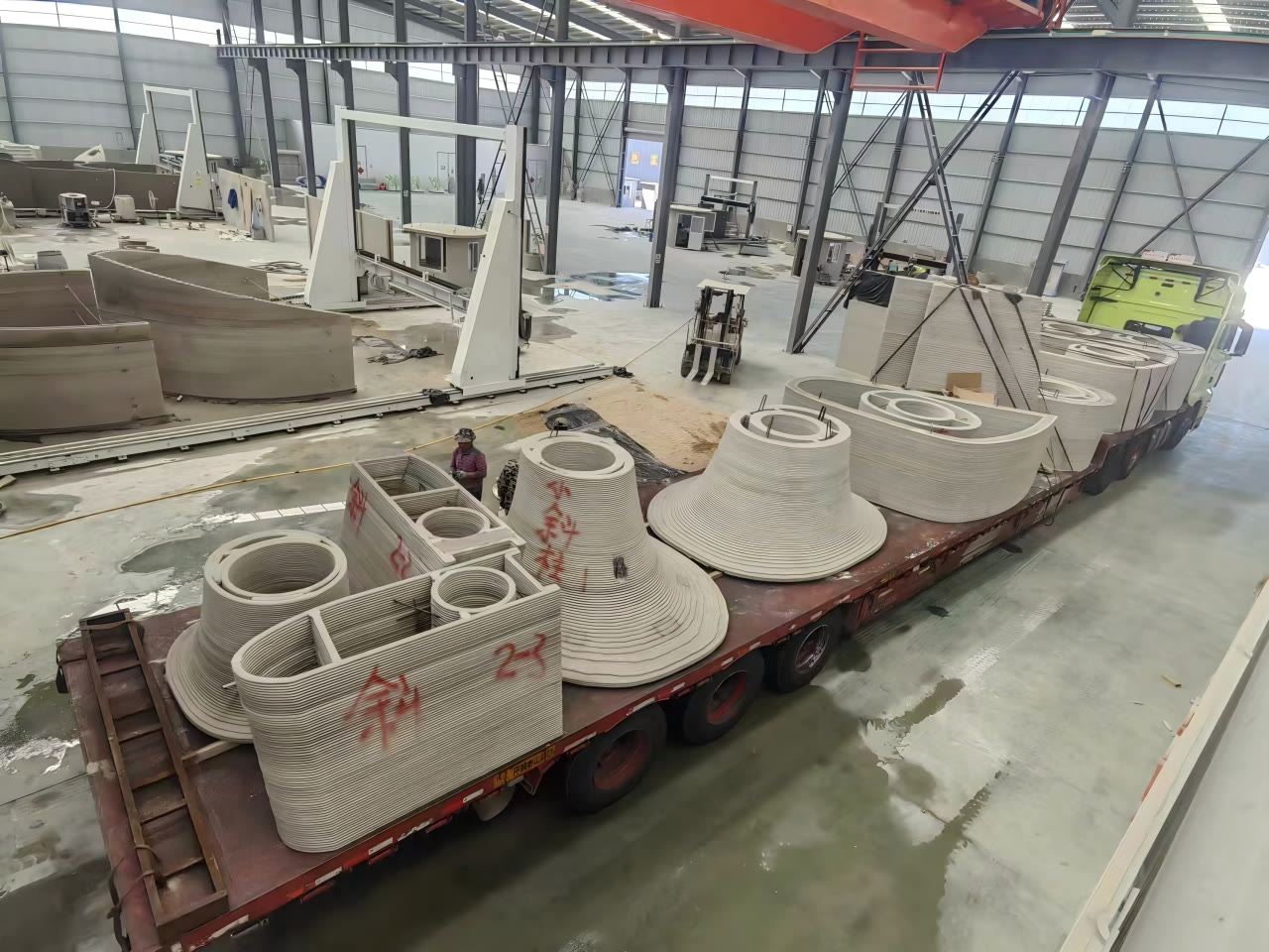 Prefabricated components printed at the factory before delivery to site.