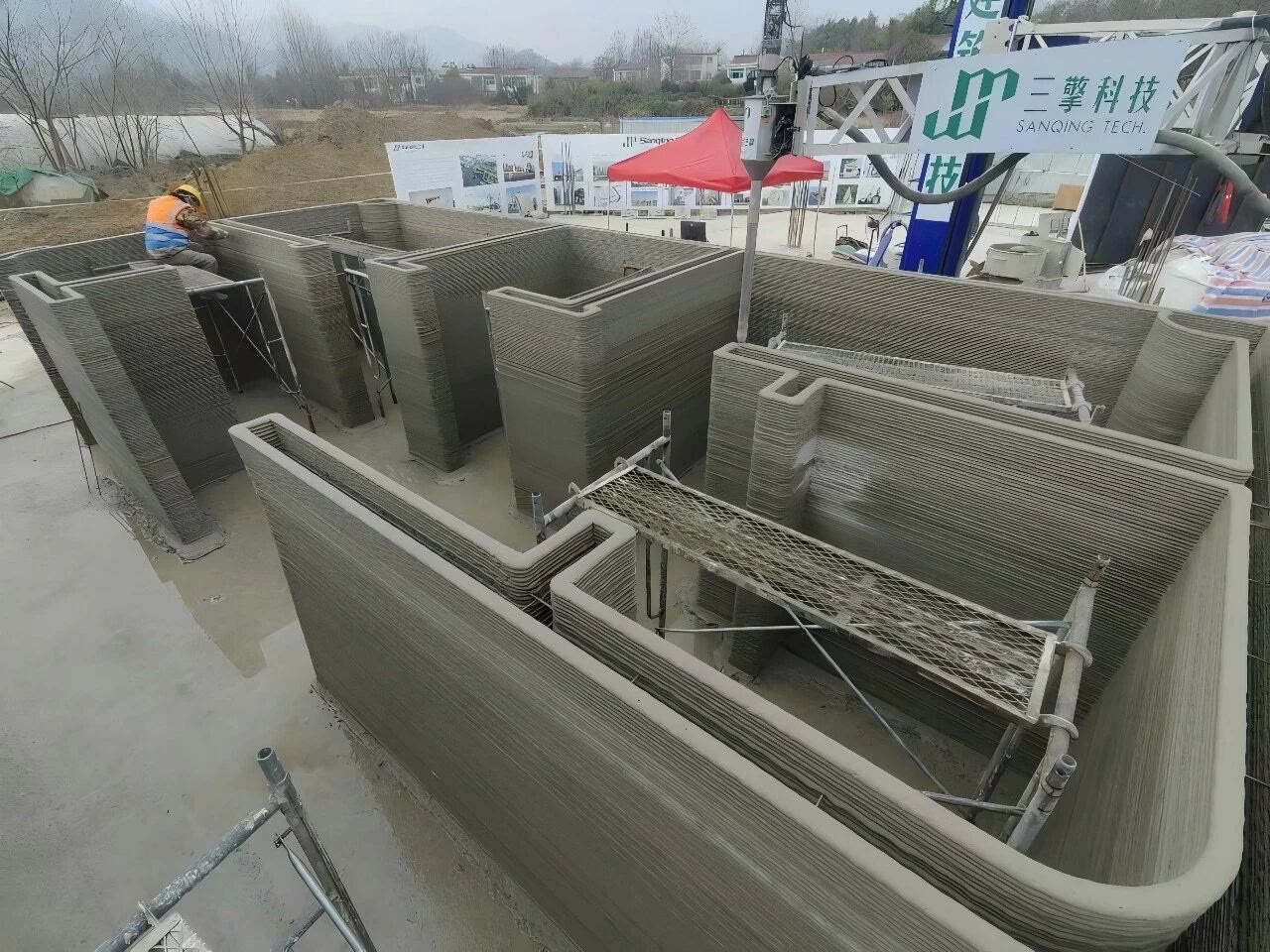 The freeform concrete walls, printed layer upon layer.
